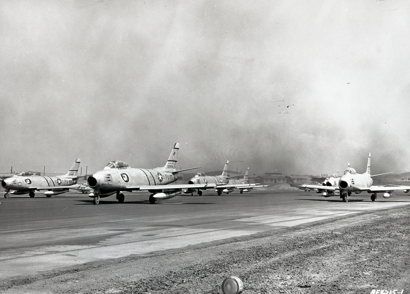 In this photo we can see plumes of black smoke flowing from the exhaust of these North American Aviation F-86A Sabre interceptors. The jet engines were powerful for this time period which gave the American pilots a significant advantage in both speed and operational ceiling.  Also, the wing configuration allowed for tight turns and nimble maneuvering at all speeds.