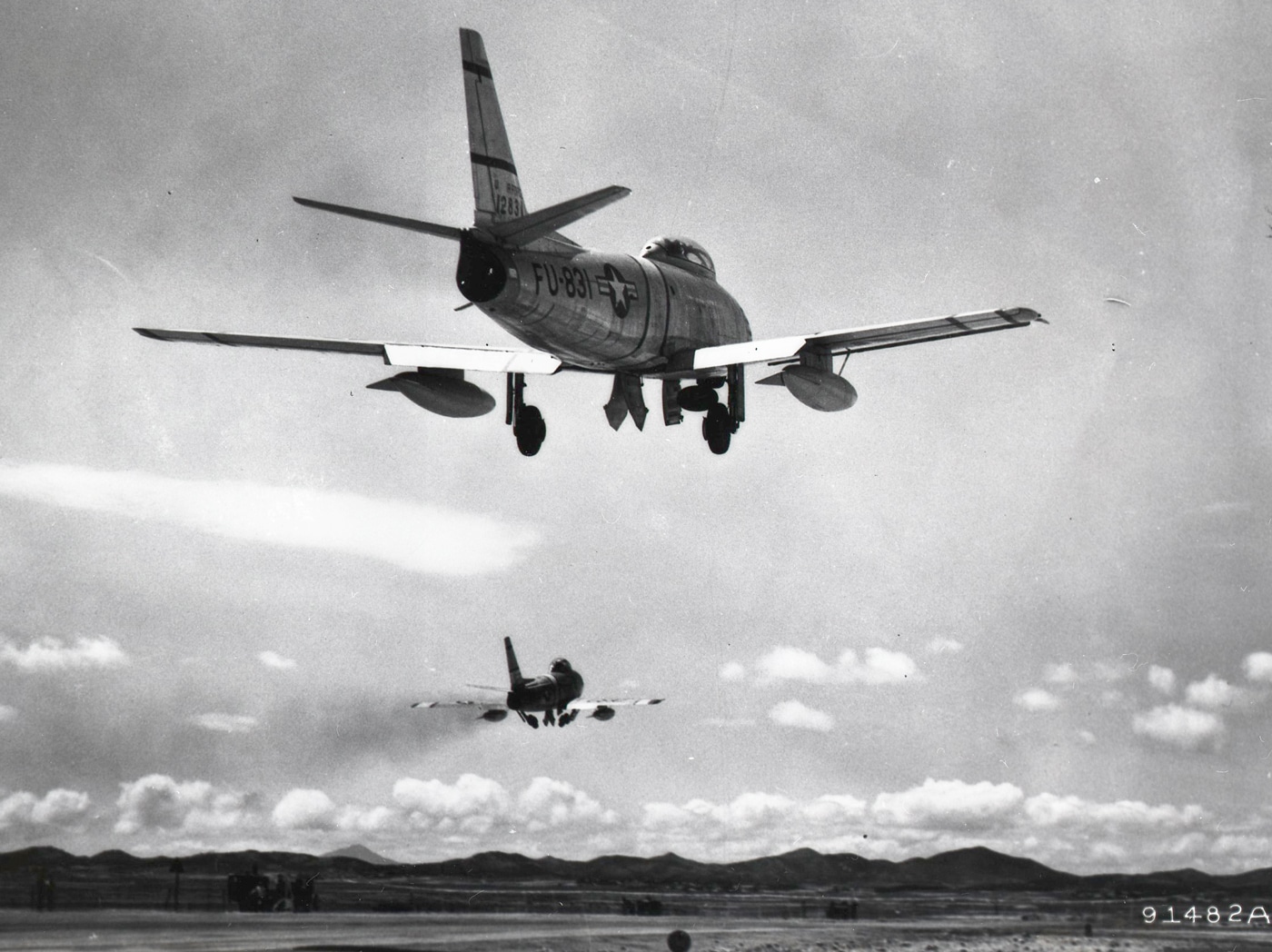 Here we see a pair of North American F-86a Sabre transonic jet fighter aircraft take off to do battle with the communist invaders. The armament of these jets included six (6) M3 Browning machine guns chambered for the .50 BMG cartridge. These .50 caliber guns were in the nose of the aircraft. Other versions of the plane were fitted with 20mm cannons, unguided rockets and napalm. This made them effective as mobile artillery that could bring in a lot of firepower to front line troops in contact with the enemy. 