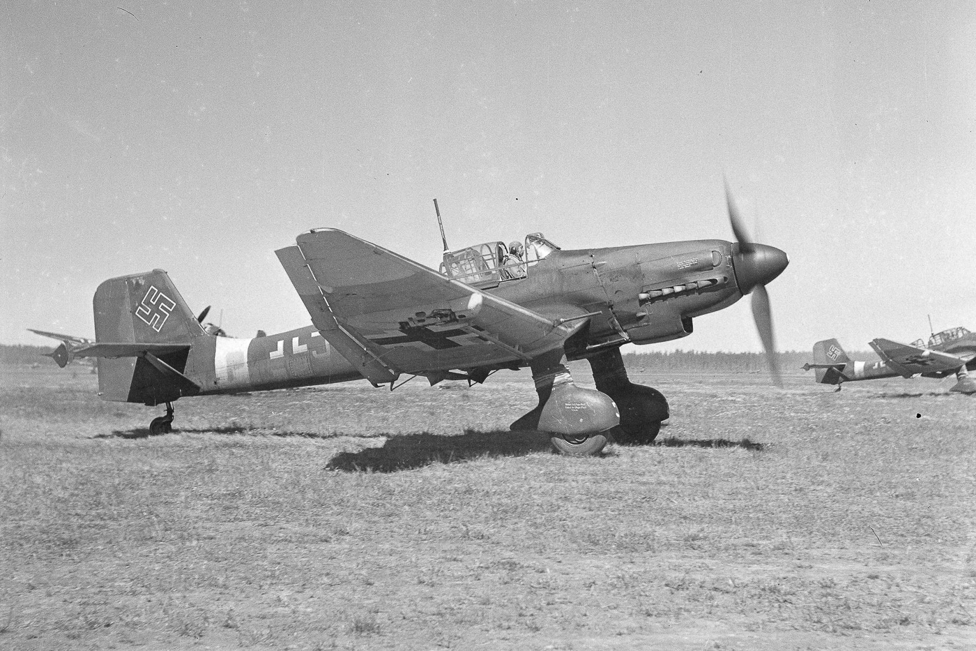 In this photo we see a German Stuka returning from a successful bombing mission. The Junkers Ju 87, popularly known as the "Stuka", is a German dive bomber and ground-attack aircraft. Designed by Hermann Pohlmann, it first flew in 1935.