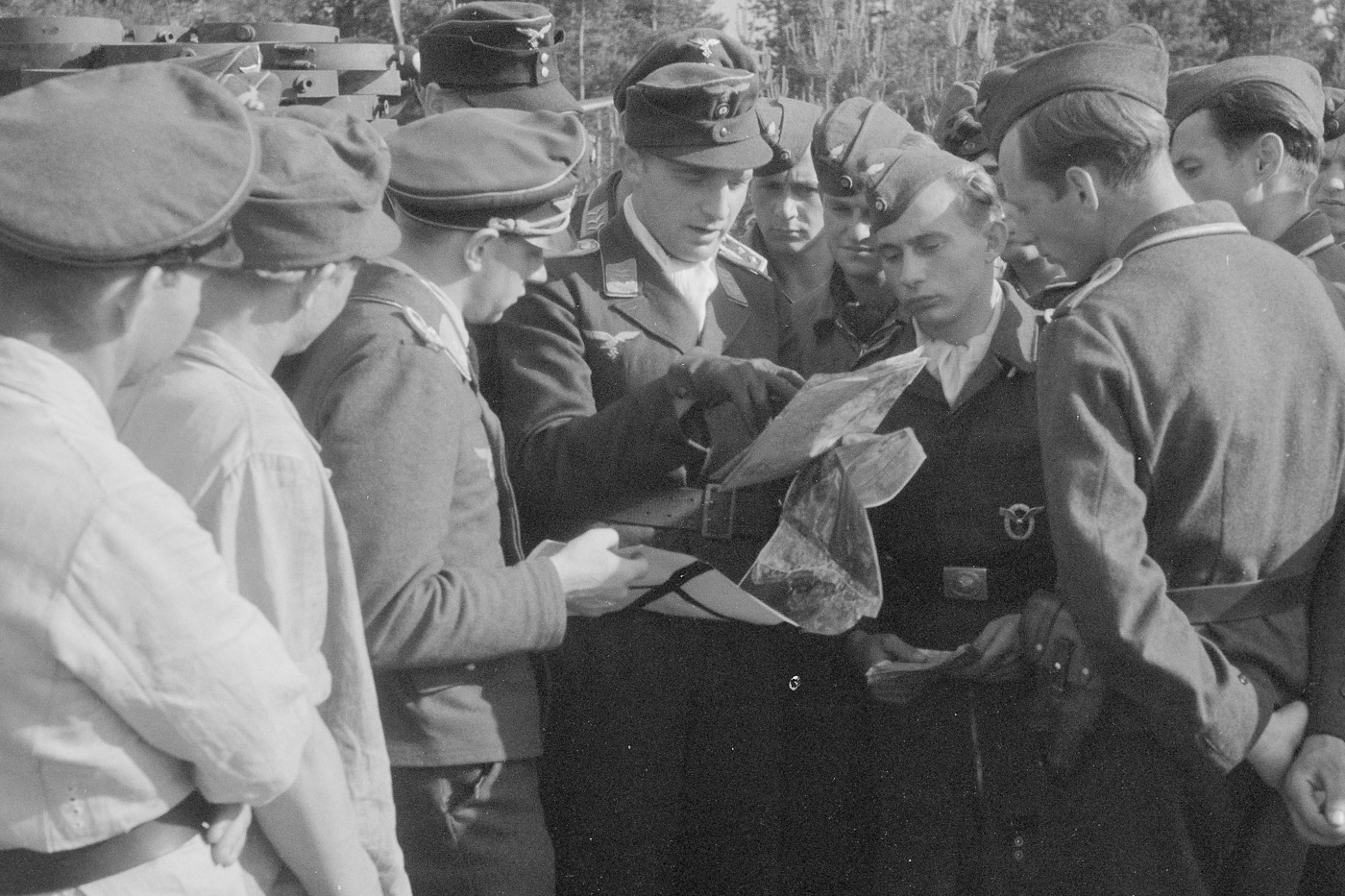 In this image we see the commander of a Stuka dove bomber squadron briefing his men on the upcoming mission against the Soviet Union. In these fierce battles, the Stukas flew many sorties and the Stuka could make a major impact on the outcome of the battle. They were powerful air support platforms that saved many units from annihilation. 