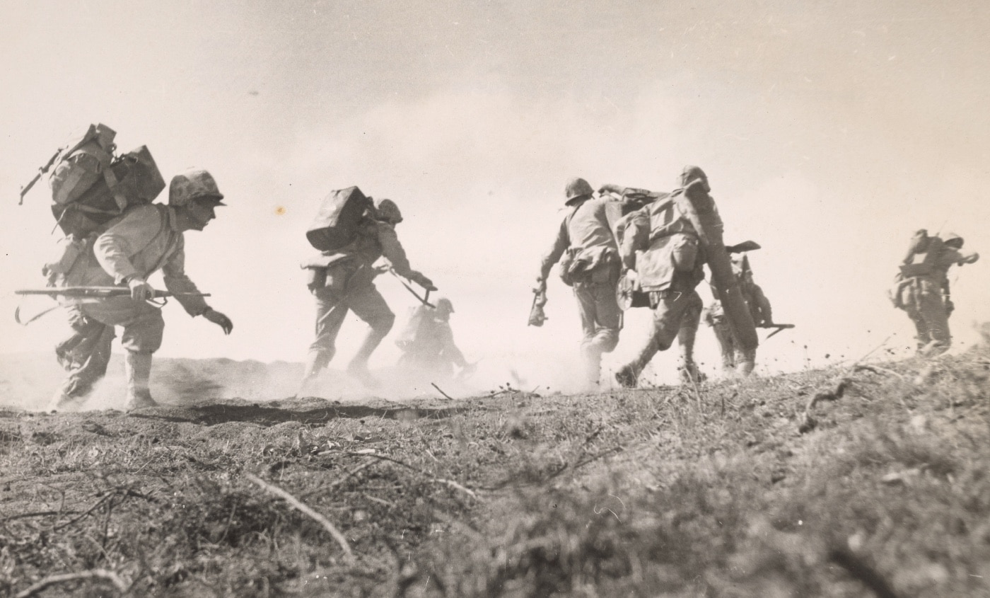 In this photo, we see Marines with military radios or two-way radios moving with the attack inland. Defended by General Tadamichi Kuribayashi, Iwo Jima was one of the toughest battles in Marine Corps history. It took more than five weeks resulting in heavy losses of Navy and Marine servicemen.