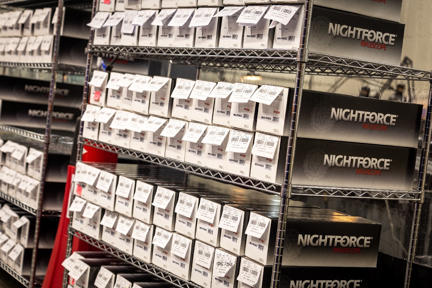 In this digital image, we see many shelves of Nightforce scopes ready for shipping.
