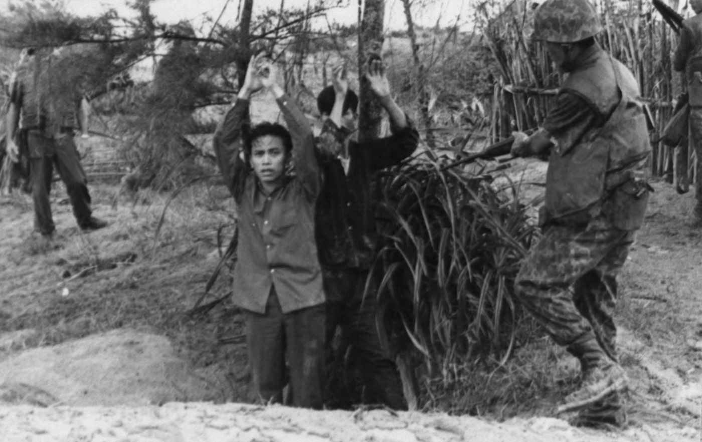 In this photograph, Republic of Korea Marines point rifles at terrorists who were setting up an ambush from a cave. The VC prisoners were taken into custody and turned over to investigators