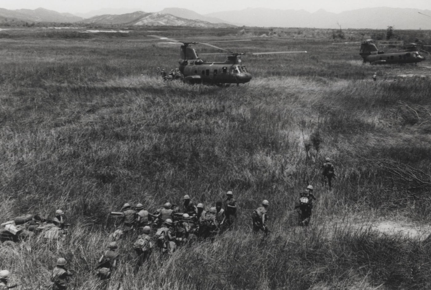 In this photo, ROK Marines load onto CH-46 helicopters in a grassy field. 	The Boeing Vertol CH-46 Sea Knight is an American medium-lift tandem-rotor transport helicopter powered by twin turboshaft engines. It was designed by Vertol and manufactured by Boeing Vertol following Vertol's acquisition by Boeing. Development of the Sea Knight, which was originally designated by the firm as the Vertol Model 107, commenced during 1956.