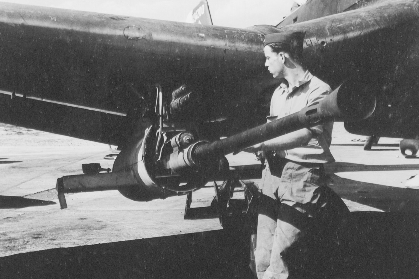 in this 1945 photograph, Staff Sergeant Charles N. Culver of Rosser Texas examines a JU-87G Stuka equipped with 37mm cannons. 