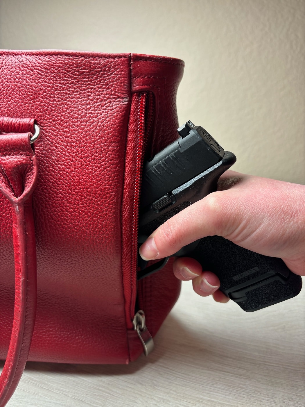 As shown here, the Springfield Armory Hellcat fits easily into a purse holster.