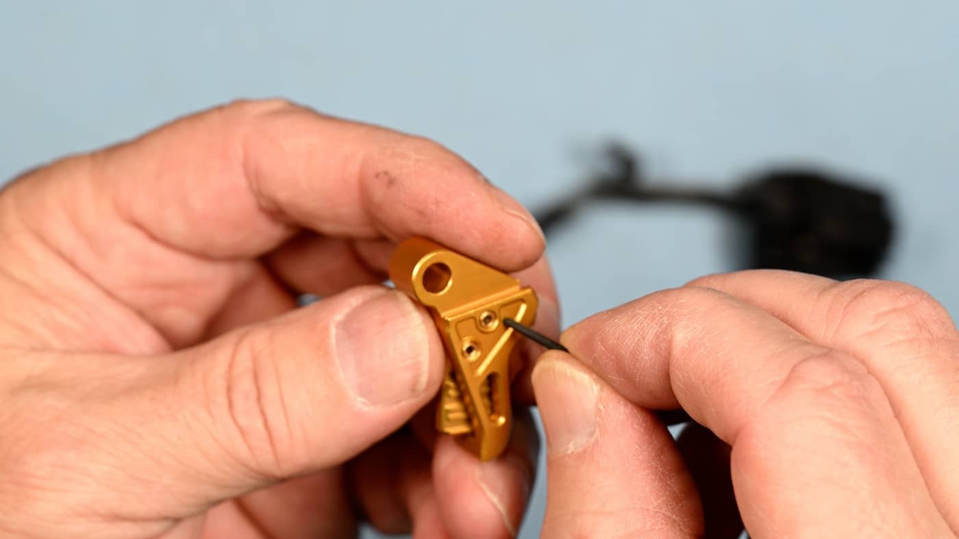 In this photograph, the author shows us a close-up shot of the Tyrant CNC trigger. Sometimes called a trigger shoe, a trigger is a mechanism that actuates the function of a ranged weapon such as a firearm, airgun, crossbow, or speargun. The word may also be used to describe a switch that initiates the operation of other non-shooting devices such as a trap, a power tool, or a quick release.