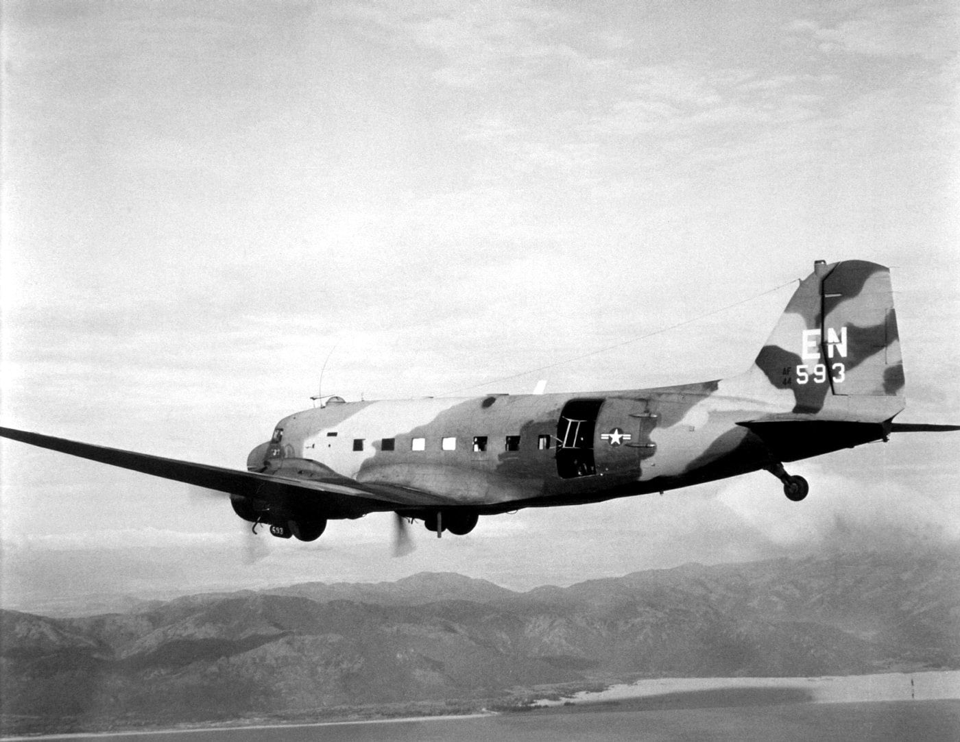 In this digital picture,  we see an AC-47 gunship flying near Saigon, South Vietnam during the Vietnam War. Also known as "Puff the Magic Dragon," these aircraft typically had three 7.62 mm miniguns mounted on the left side of the aircraft. The aircraft carried up to 8 crew members including the pilot and was the start of a robust gunship program in the United States military. A gunship is a military aircraft armed with heavy aircraft guns, primarily intended for attacking ground targets either as airstrike or as close air support.