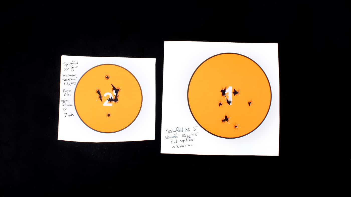 In this photo are two targets comparing the relative accuracy of the XD Tactical vs XD Sub-Compact 9mm pistols. 