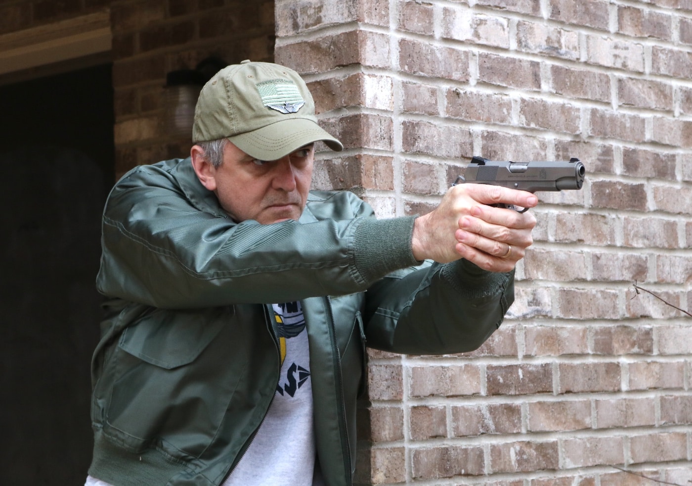 In this photograph, the author Will Dabbs MD points the Springfield Armory Garrison 4.25" 1911 pistol during a training exercise with the firearm. Guns are deadly weapons and safe training should be done under the supervision of trained professionals.