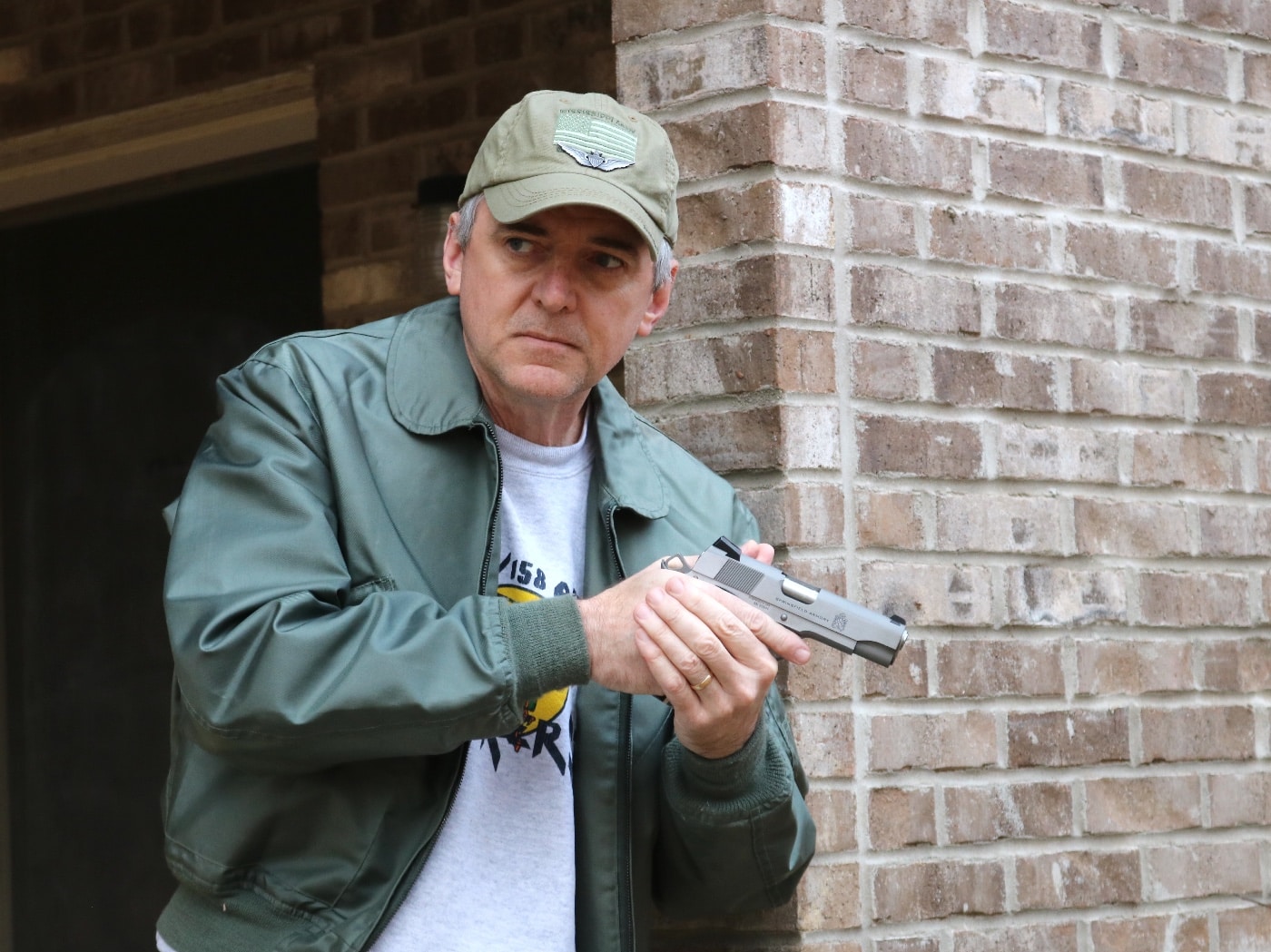 In this picture, the author is shown testing the Springfield Armory Garrison 4.25" M1911 pistol. This one is chambered in 9×19mm Parabellum. The 9×19mm Parabellum is a rimless, tapered firearms cartridge. 