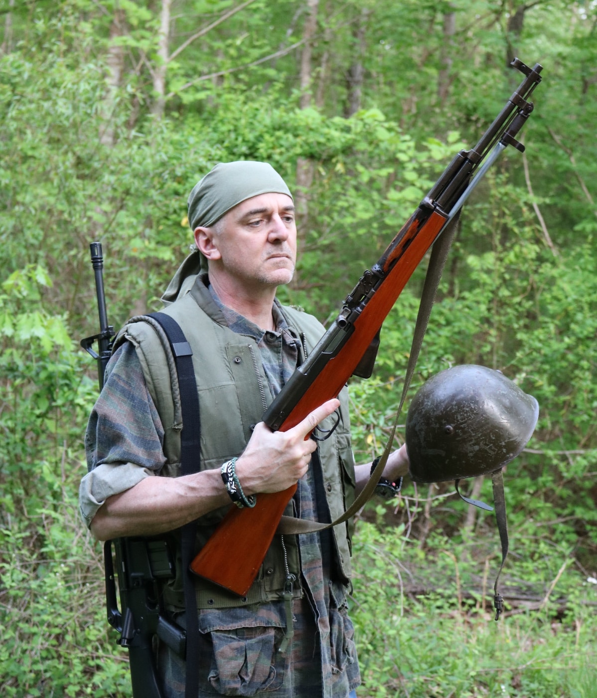 In this photo, we see the author with the Chinese SKS rifle he discusses in the article. The SKS is a semi-automatic rifle designed by Soviet small arms designer Sergei Gavrilovich Simonov in 1945. The SKS was first produced in the Soviet Union but was later widely exported and manufactured by various nations.