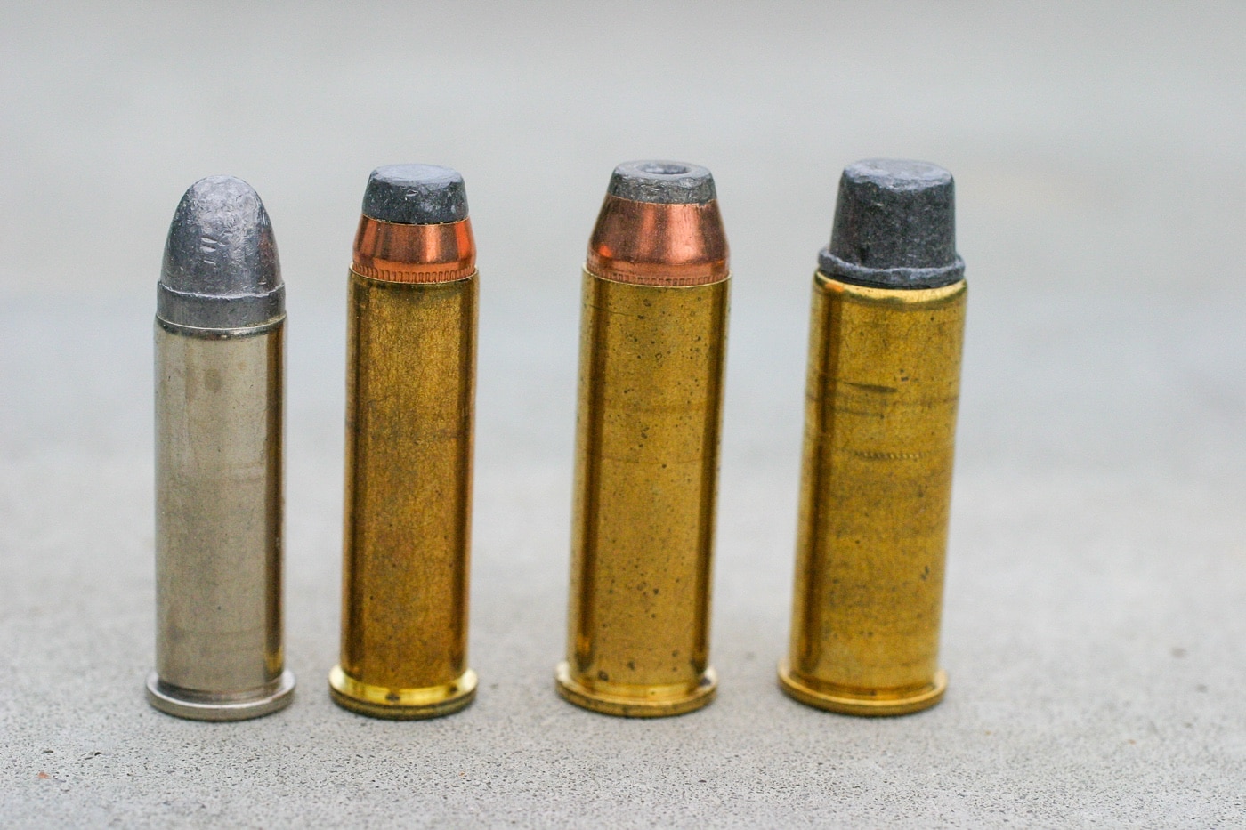 Shown in this digital image are four cartridges for revolvers. Each uses a different projectile which is the point to the illustration. From left to right, they are a lead round nose, semi-jacketed soft point bullet, a semi-jacketed hollow point bullet and a lead semi-wadcutter. A special note about the LSWC bullet — some effective hollow point bullets are made with semi-wadcutters. They have an open front, deep cavity and use soft lead to increase the probability of expansion.