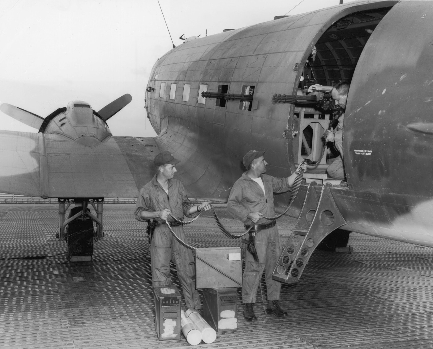 In this photo, we see three Air Force crewmen loading belts of 7.62x51 NATO ammunition into the M134 Miniguns of an AC-47 gunship. Called the AC-47, it was the first fixed-wing aircraft set up as a gunship as part of an Air Force mission to provide close air support to troops in contact throughout South Vietnam. The Air Force used a total of five aircraft to form the first gunship squadron. As new aircraft came onto Nha Trang Air Base, they were folded into the squadron. 