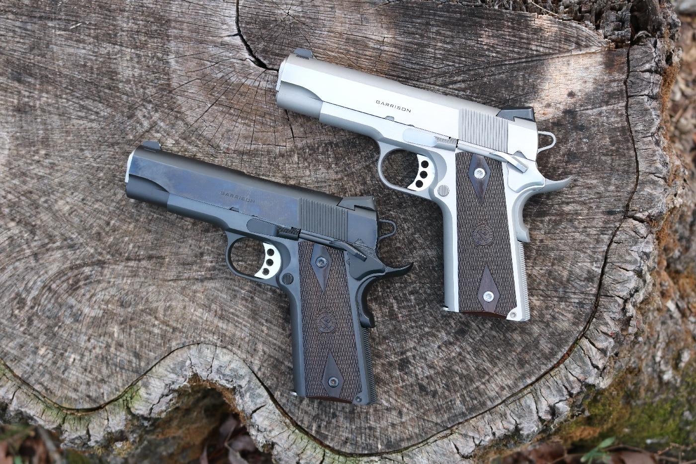 In this image, we see two Springfield Garrison 4.25 inch pistols - one in a blued finish and one in a stainless finish. The guns are chambered in both 9mm and .45 ACP.