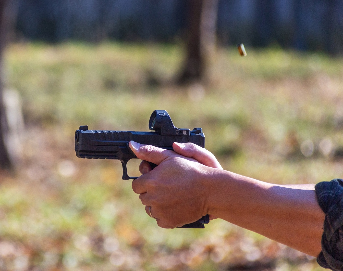 Shown in this photo is the author shooting the Echelon with the BlackSteel Grip Control. A spent 9mm brass case is flying through the air.