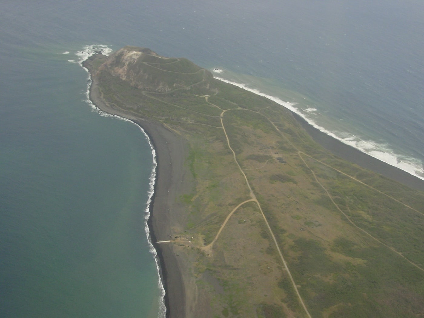 In this overhead photo of the island, we see Mount Suribachi at the south end. After Iwo Jima had been captured, the Marine Corps history division documented the anniversary of the battle with the Navy and Marine Corps. Iwo Jima's strategic importance has been questioned in recent years, but at the beginning of the battle, planting a flag on Iwo Jima seemed to be necessary.