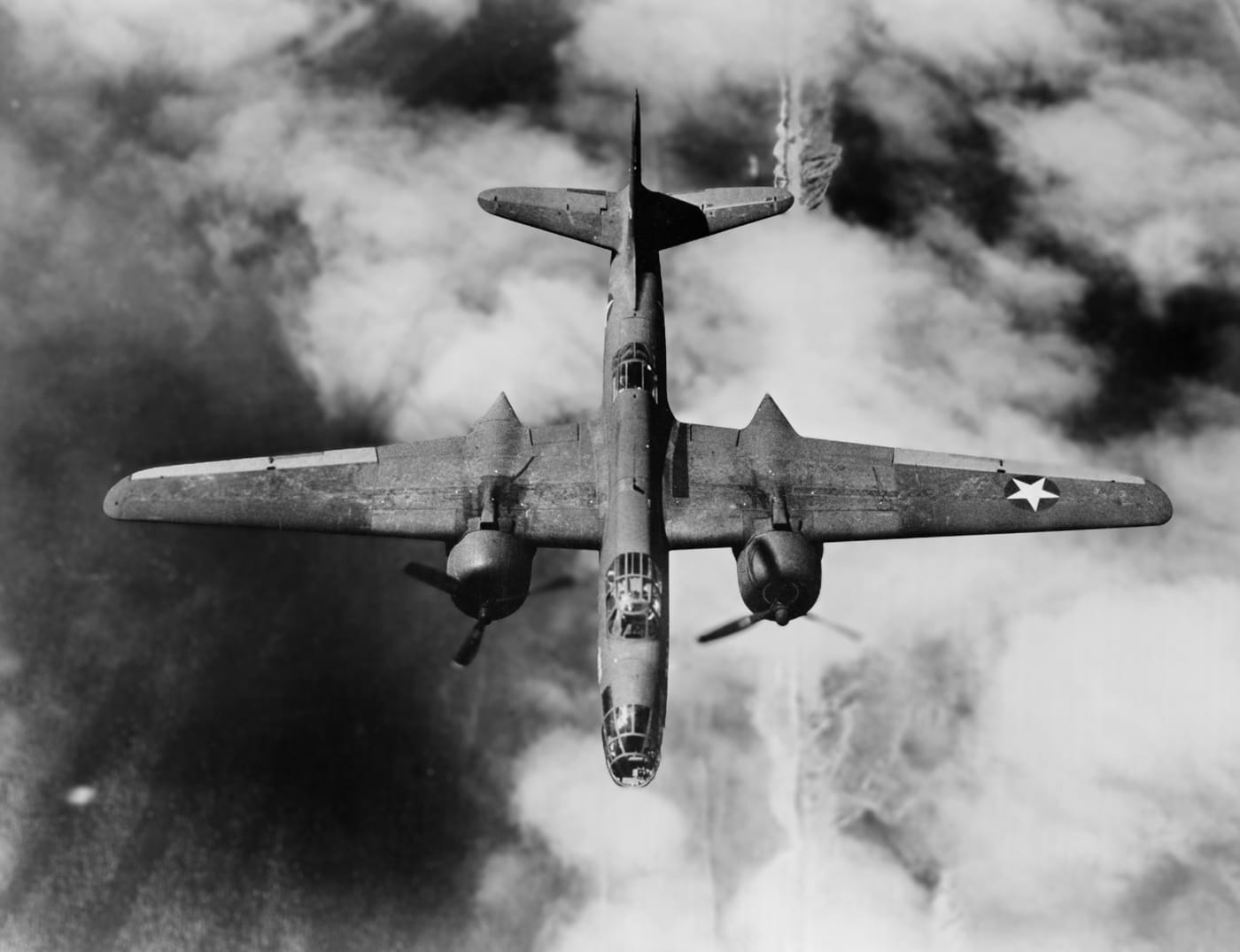 In this photo, we see the top of an A-20 Havoc while in flight over Europe. The Douglas A-20 Havoc is an American medium bomber, attack aircraft, night intruder, night fighter, and reconnaissance aircraft of World War II.