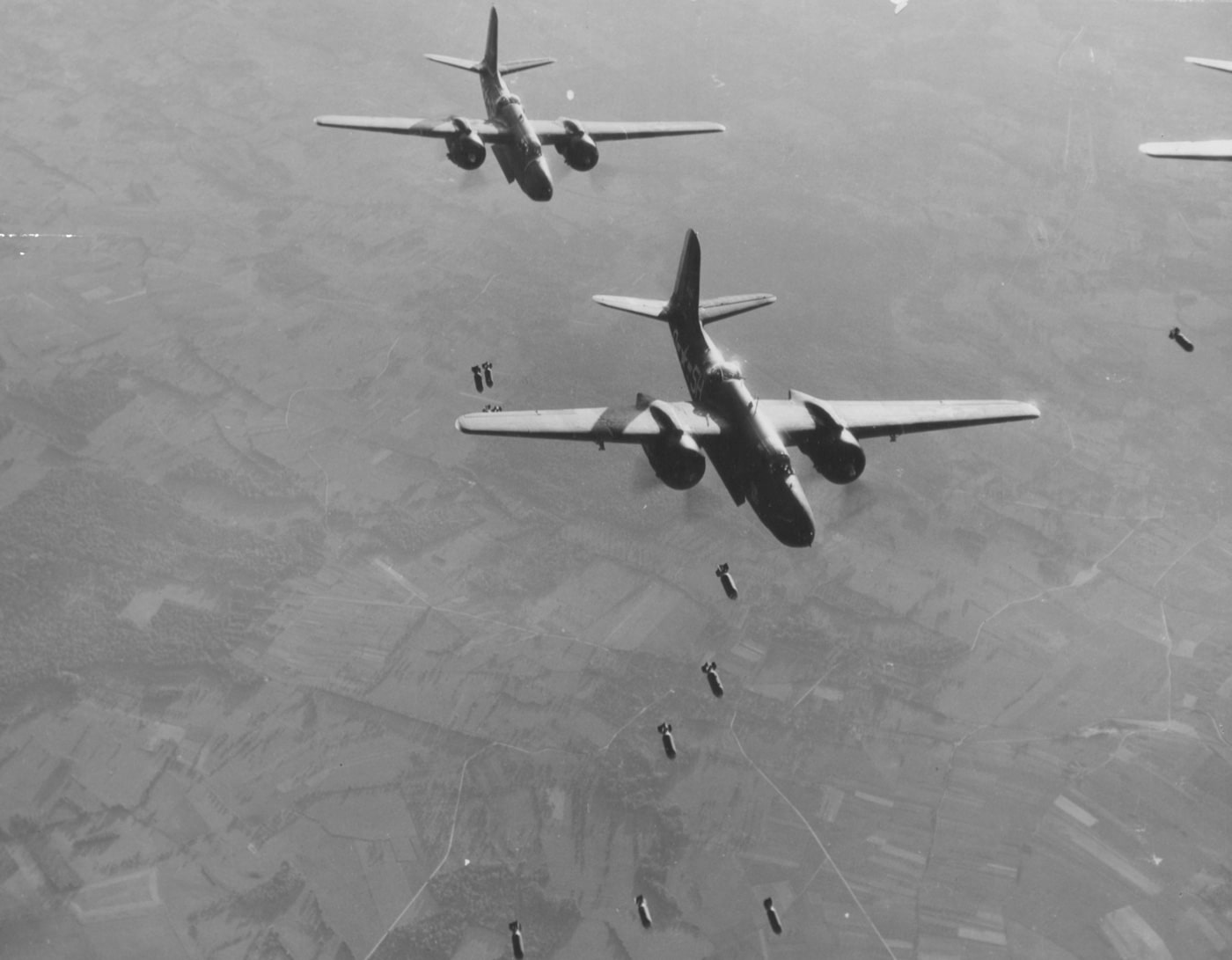 The images shows a squadron of A-20 Havocs bombing V-1 launch site in northern France.