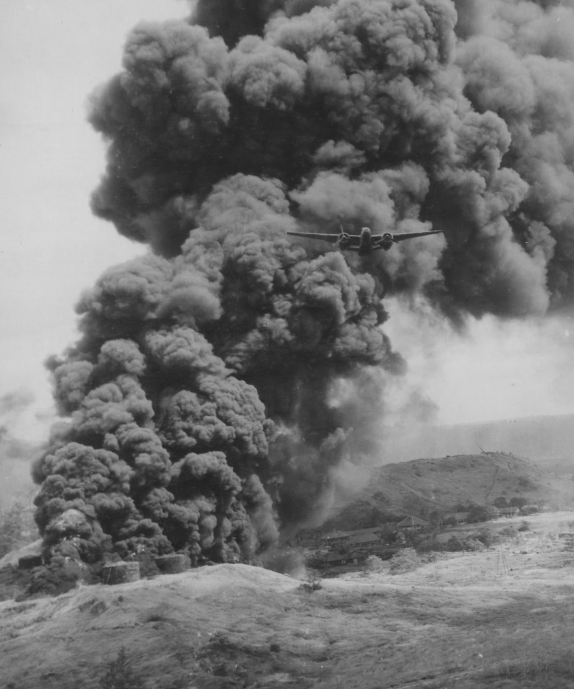 This photo shows a low flying A-20 Havoc flying away from the Beola oil fields in the Dutch East Indies. Now known as Indonesia, the area had been held by Japanese forces when 75 A-20 Havocs of the 312th Bomb Group on July 14, 1944. 