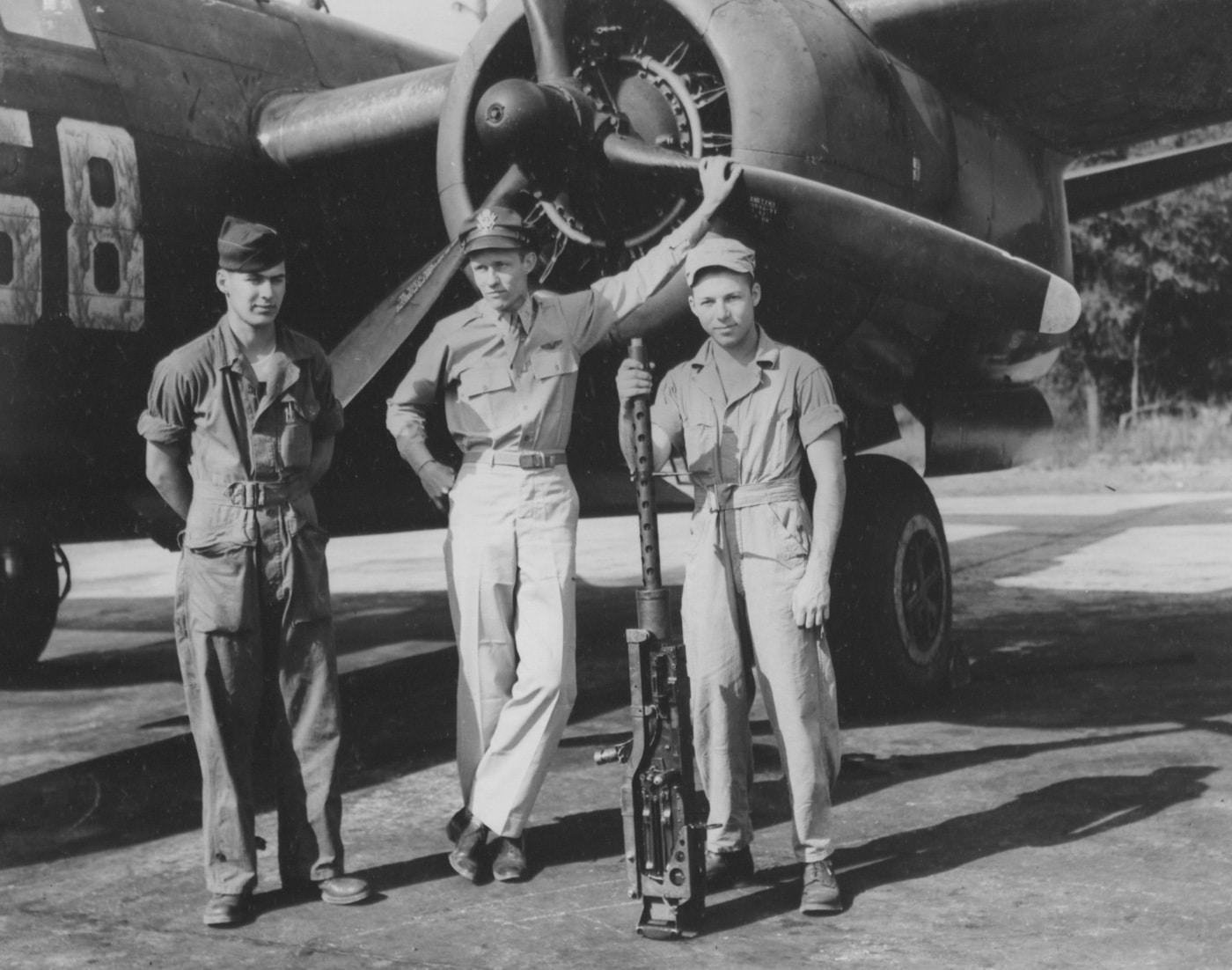 In this image, we see the three crew members of an A-20 assigned to the 9th Air Force based in France. one of the crewmen holds a Browning M2. The M2 machine gun or Browning .50 caliber machine gun is a heavy machine gun that was designed near the end of World War I by John Browning.