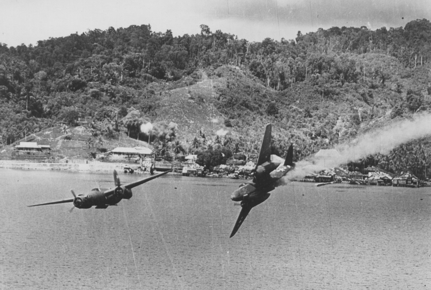 In this image, we see a Douglas A-20 Havoc caught by Japanese anti-aircraft flak, swerves out of control, and crashes into the ocean. All men were killed.