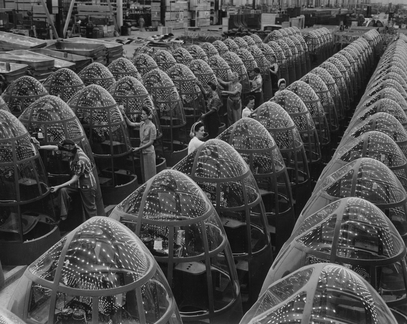 Shown here are rows of A-20 nose glass construction during World War II in California. The plexiglas reflects the overhead lights.