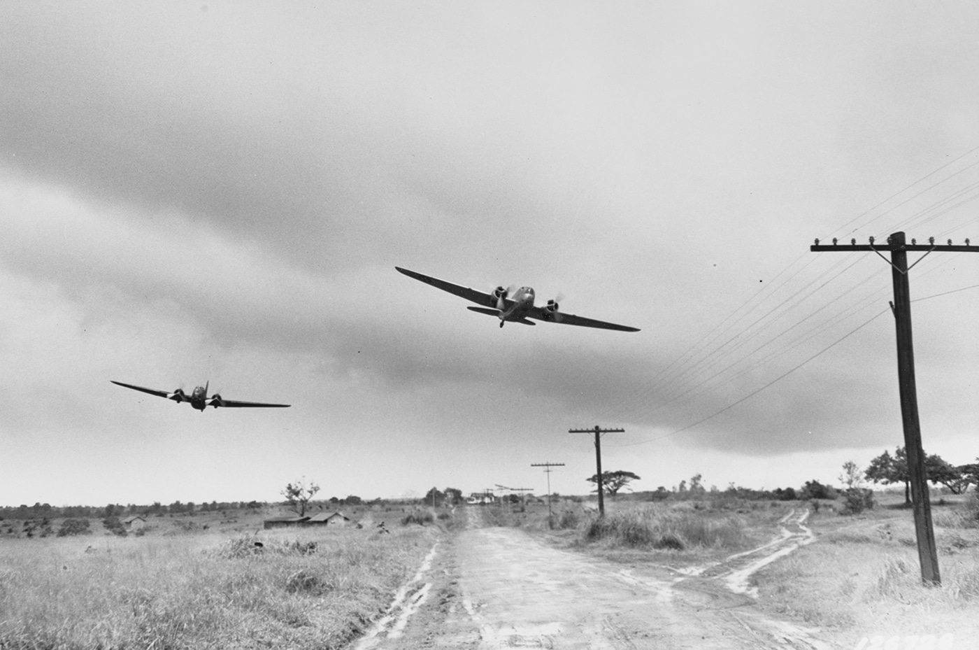 In this image, we see a pair of B-18 bombers making a simulated attack run on U.S. Army troops in the Philippines. This was part of war games to train the soldiers and pilots in tactics and combat. With the B-18s deployed outside the continental United States, they expected to see action when the inevitable war with Japan came about.