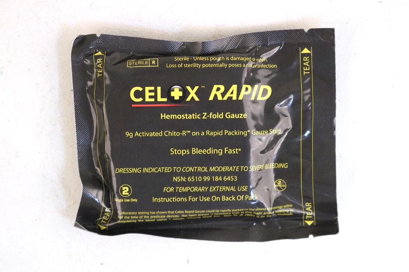 In this photograph, we see a Celox hemostatic bandage. This is good for packing a wound. 