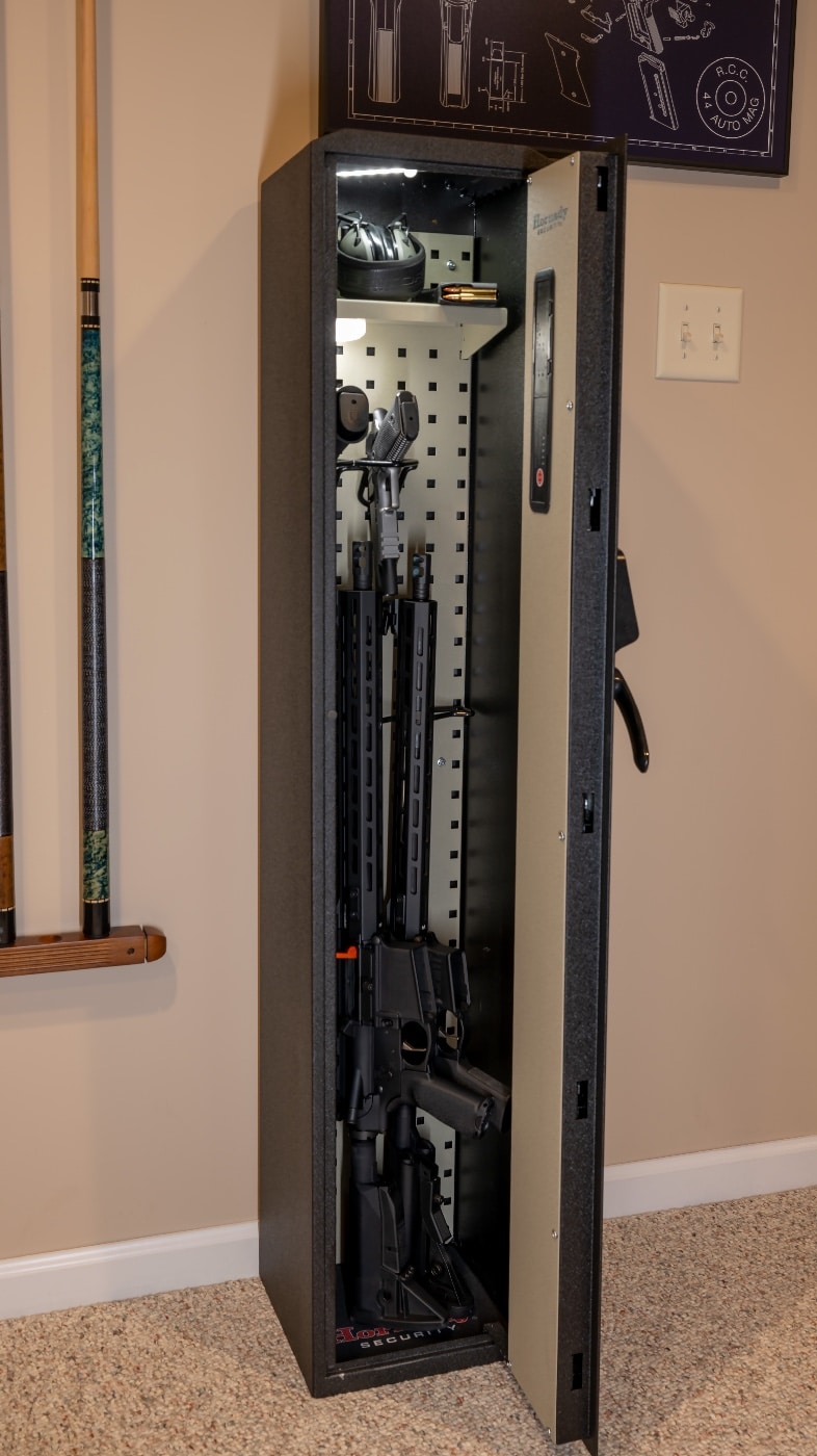 In this photo, the author opened the door to his Hornady RAPiD Safe Ready Vault to show his Springfield Armory, Inc. M1911 pistol, Springfield Armory XD 9x19mm Parabellum pistol and a pair of SAINT ar-15-style rifles. 