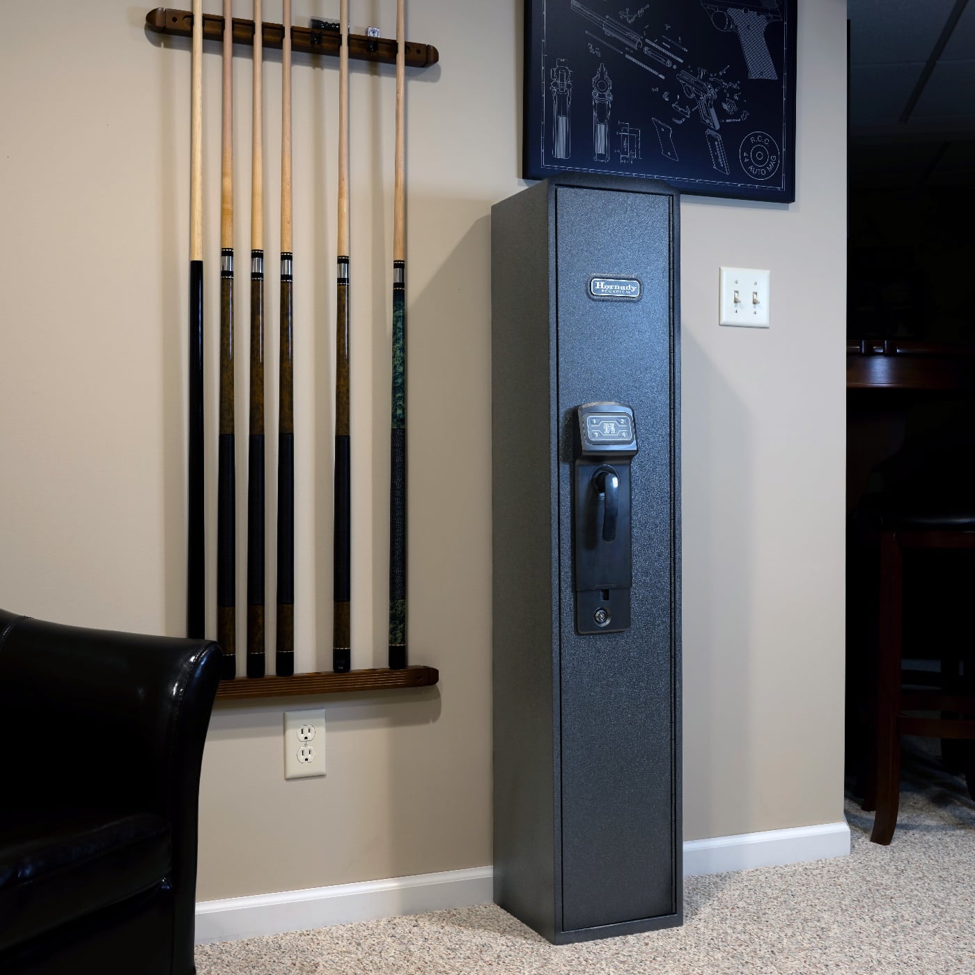 In this photo, we see the Hornady RAPiD Safe Ready Vault in his living room. A gun safe is a safe designed for storing one or more firearms and/or ammunitions. 