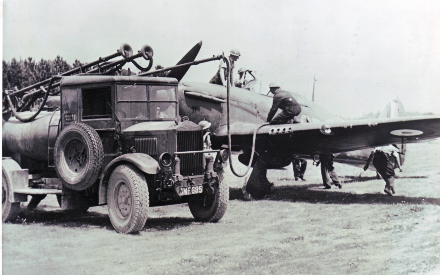 In this vintage photograph, RAF ground crews scramble to get a Hawker Hurricane reloaded during the Battle of Britain. 