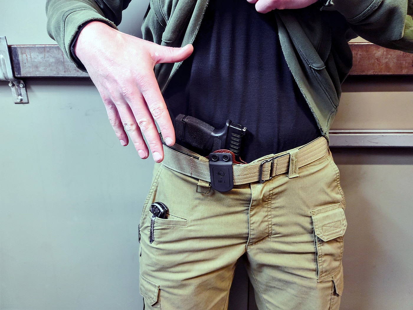 Shown in this photograph is a Springfield Armory Hellcat OSP pistol in 9mm along with the MFT holster.