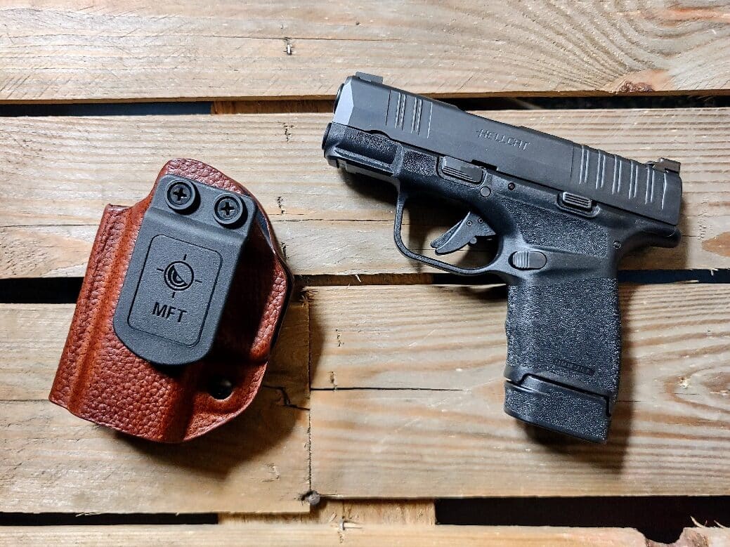 Shown in this photograph is a Springfield Armory Hellcat OSP pistol in 9mm along with the MFT holster.