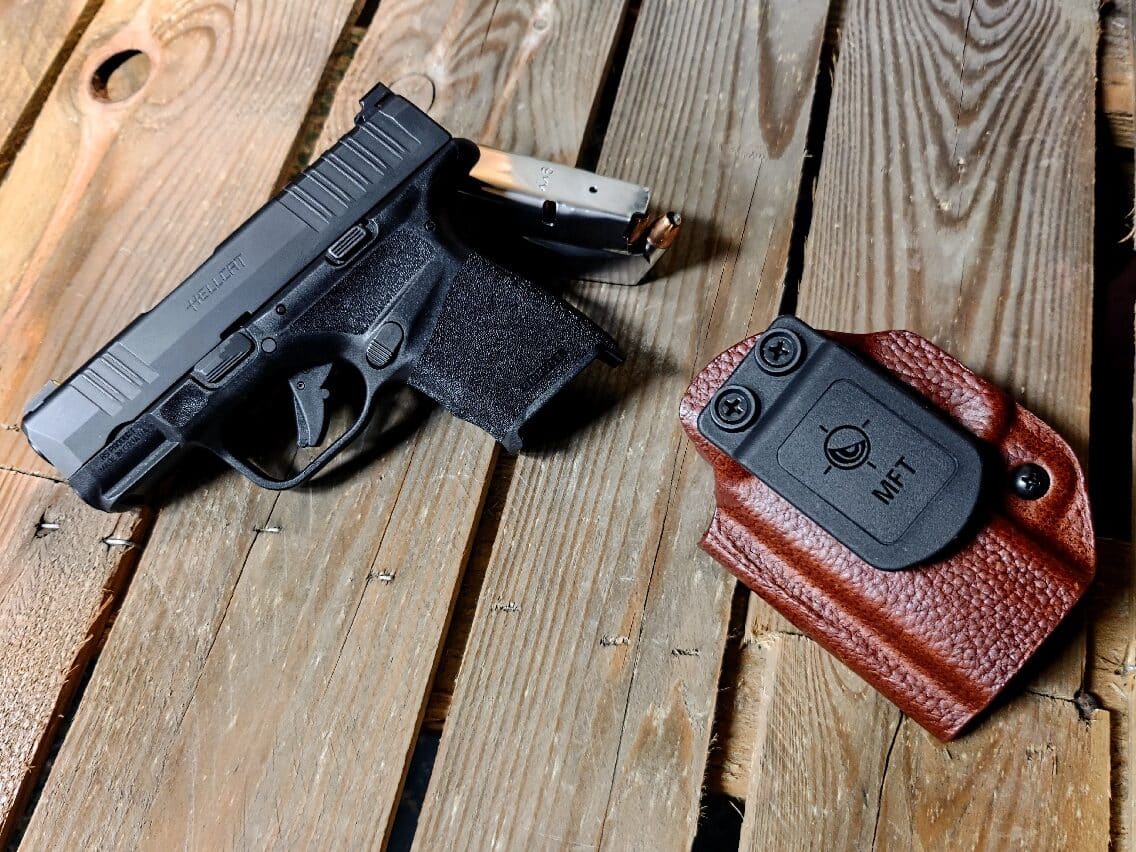 In this photo, the author shows the MFT holster he reviewed along with his 9mm Hellcat. 