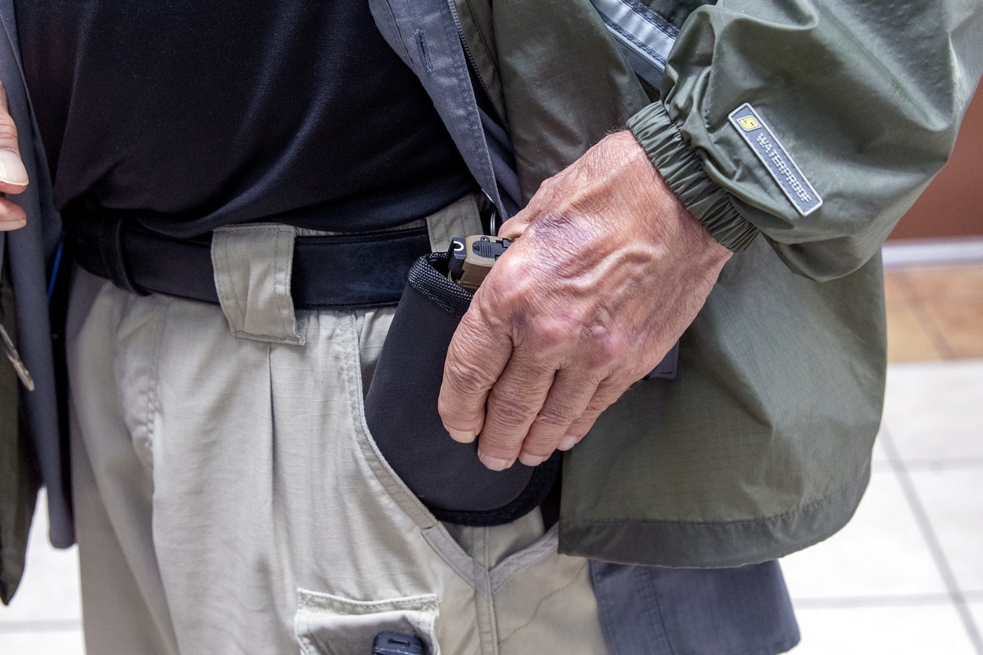 Massad Ayoob demonstrating inserting a pocket holster