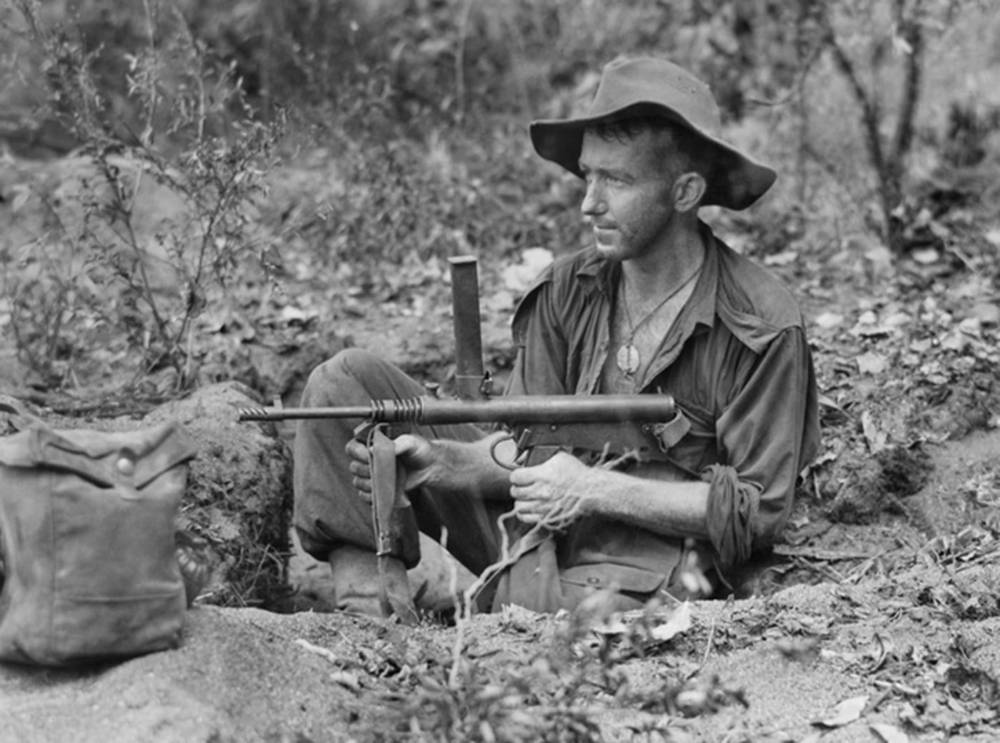 In this photo from New Guinea of an Australian soldier with his Owen SMG in WWII.