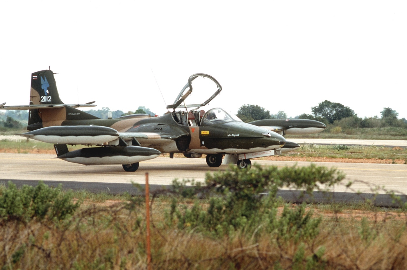 In this photograph, we see a Thai AF A-37 preparing for a mission. The Royal Thai Air Force is the air force of the Kingdom of Thailand. Since its establishment in 1913 as one of the earliest air forces of Asia, the Royal Thai Air Force has engaged in numerous major and minor conflicts.