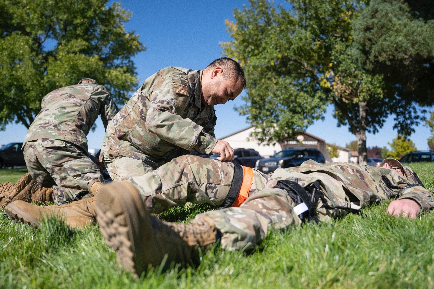 In this photograph, we see a U.S. Air Force airman learning the application of a CAT to the leg. 