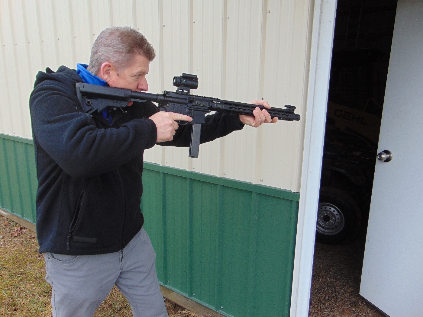 In this photo, the author is slicing the pie with his carbine. While this one is in 9mm Luger, you can also get guns made for the .40 S&W and other ammo. An ar-15 is a semi-automatic firearm offered in a range of calibers. In some ways, it is the Colt Single Action Army of the modern world. It is more powerful than a handgun with less recoil. The gun barrel, while longer than most handguns, provides additional accuracy, precision and velocity when shooting. Plus, having a stock helps ensure your bullet foes where you intend in a self-defense encounter.