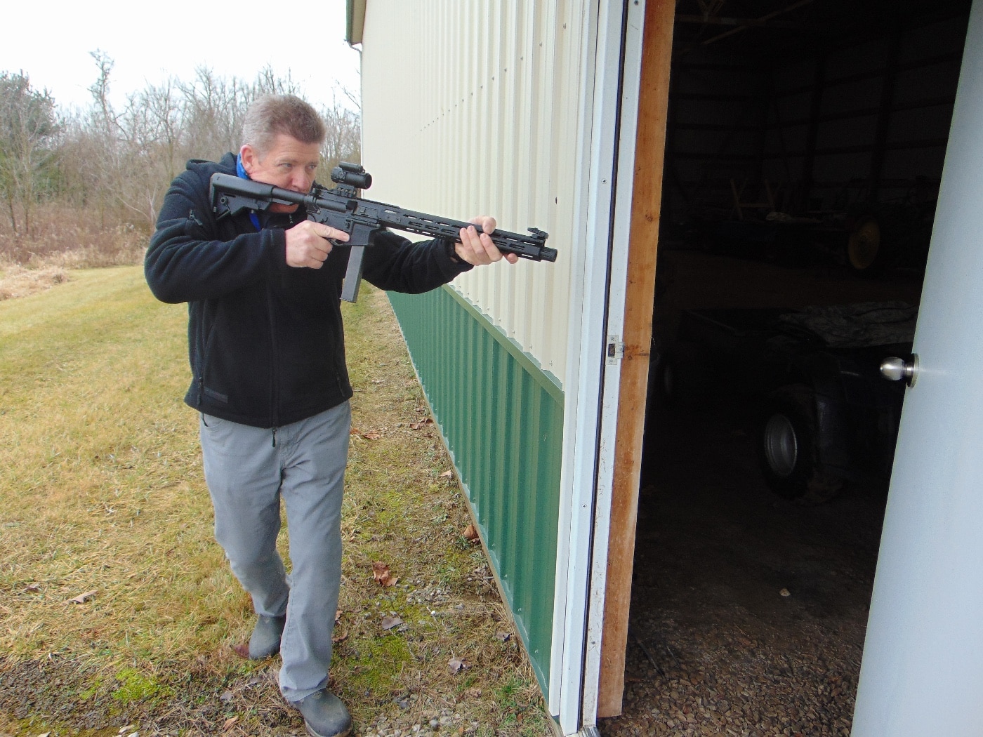 In this photograph, we see the author using his Springfield Armory SAINT ar-15 in 9mm Luger to deal with a threat on his property. These kinds of firearms are excellent - especially when fitted with a suppressor and red dot sight. They also offer a number of benefits over a shotgun or long gun made for a rifle cartridge. 