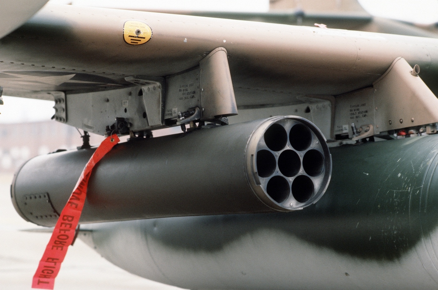 In this photo, we see a LAU-3/A rocket pod attached to the underside of a Dragonfly wing operated by the Wisconsin Air National Guard. The Wisconsin Air National Guard is the aerial militia of the State of Wisconsin, United States of America. It is, along with the Wisconsin Army National Guard, an element of the Wisconsin National Guard.