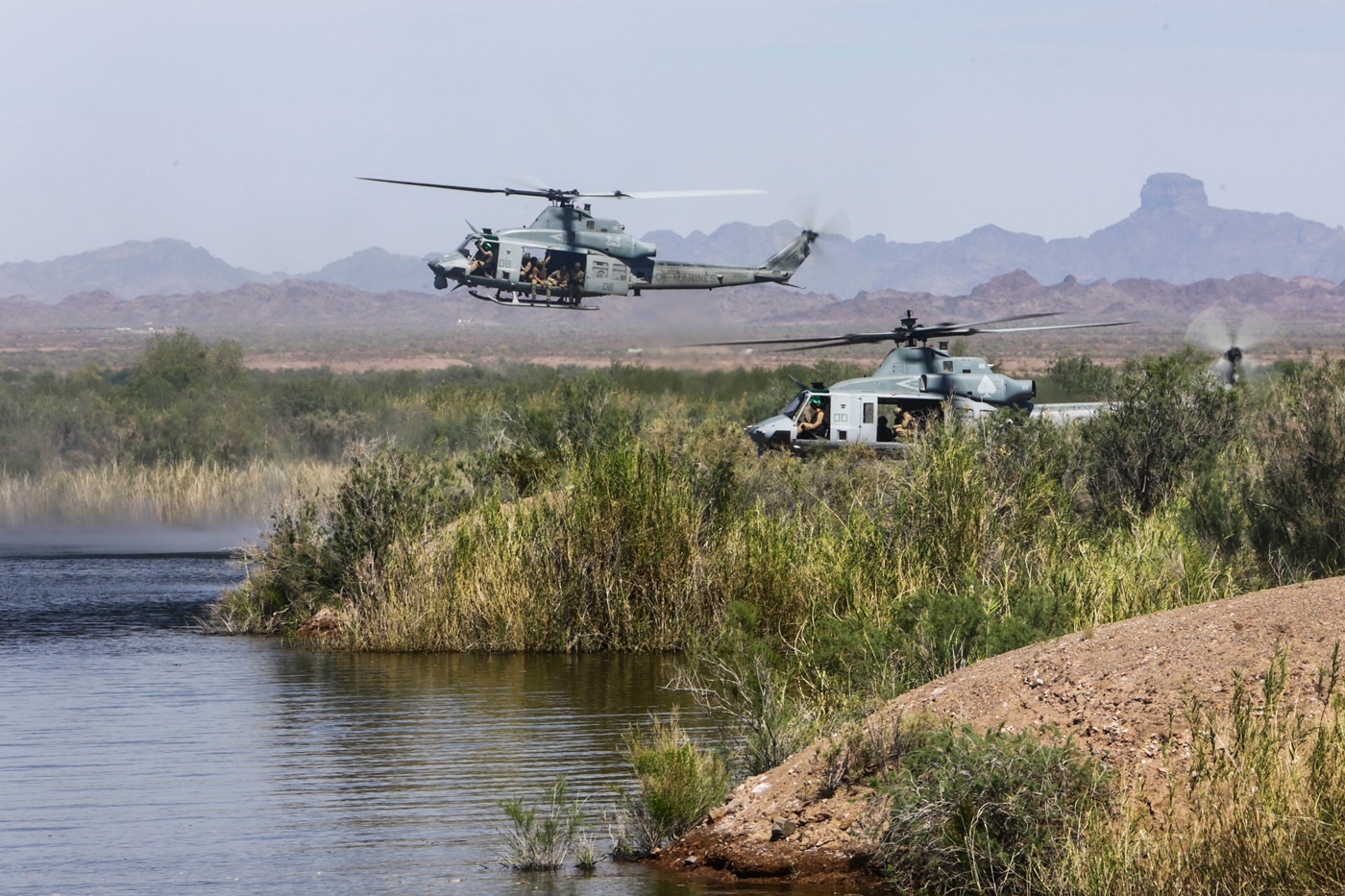 UH-1Y Huey's assigned to Marine Aviation Weapons and Tactics Squadron One (MAWTS-1) prepares to land during a helocast exercise at Ferguson Lake near Yuma, Ariz., April 3, 2015. The exercise is part of a seven-week training event hosted by MAWTS-1 cadre. MAWTS-1 provides standardized tactical training and certification of unit instructor qualifications to support Marine Aviation Training and Readiness and assists in developing and employing aviation weapons and tactics. (U.S. Marine Corps photograph by Staff Sgt. Artur Shvartsberg, MAWTS-1 COMCAM/Released)