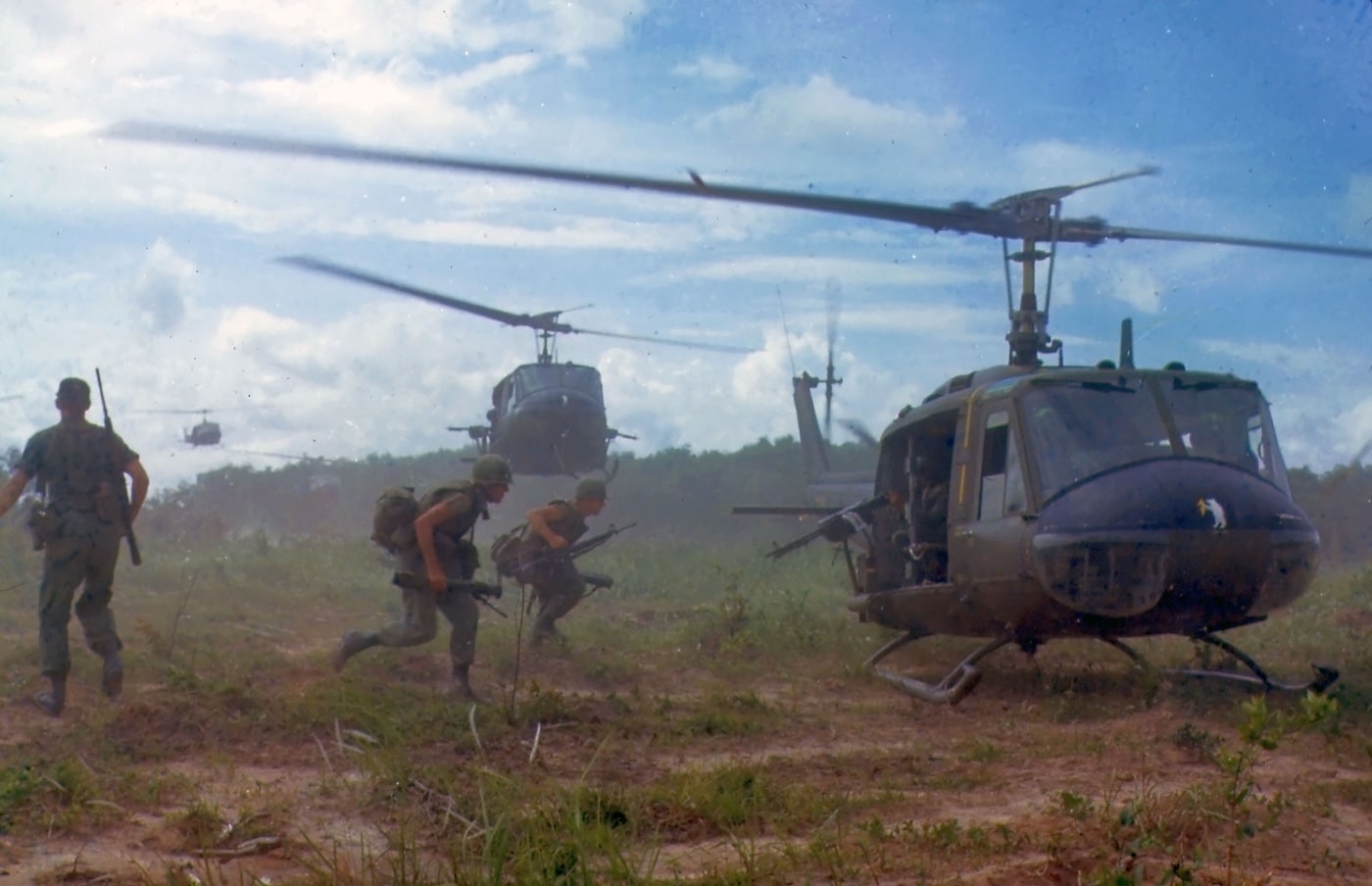 In this image, we see soldiers of the United States Army 25th Infantry Division loading onto Bell UH-1 Iroquois utility helicopters to conduct search and destroy missions in South Vietnam.