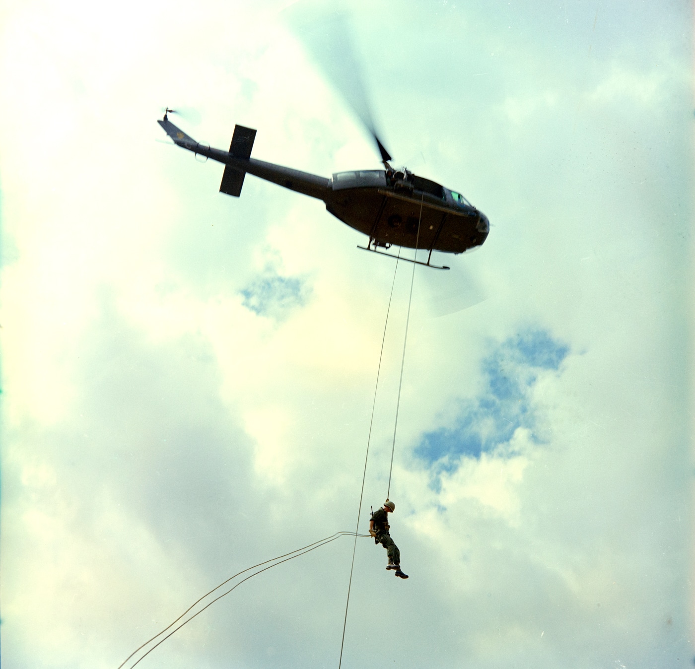 In this photo, we see a U.S. Army soldier repelling from a UH-1D helicopter during the Vietnam War. The Iroquois served many roles including command and control operations, insertion of troops, transport of supplies and medical evacuation. Hueys have served in these roles for decades ever since. 