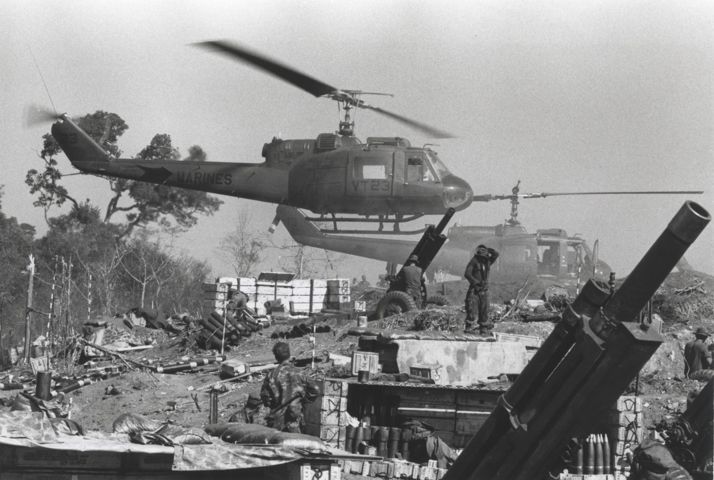 In this photo, Marine artillery crews get reconnaissance and aerial support at their firebase where they were supporting Marine infantry conducting sweep and clear missions. The attack helicopters remained in common use with rockets and machine guns until the end of the conflict.