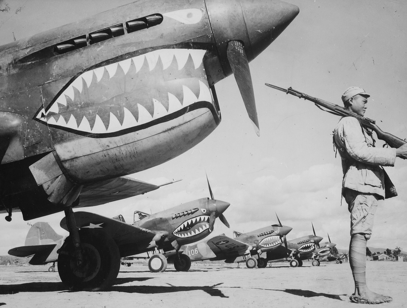 Flying Tigers P-40 planes guarded by Chinese soldiers