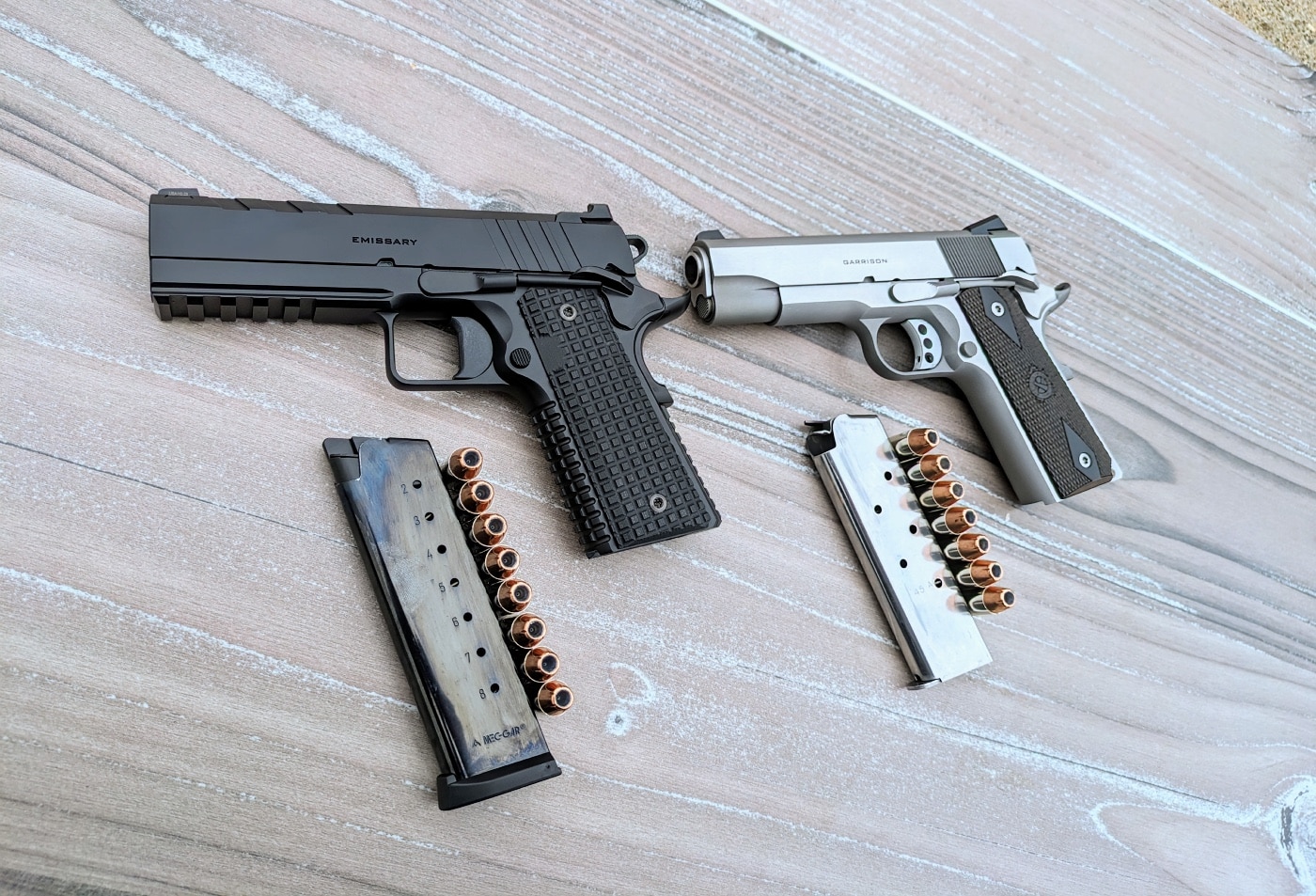 Garrison vs Emissary comparison corrosion ergonomics physics weapon design firearm components