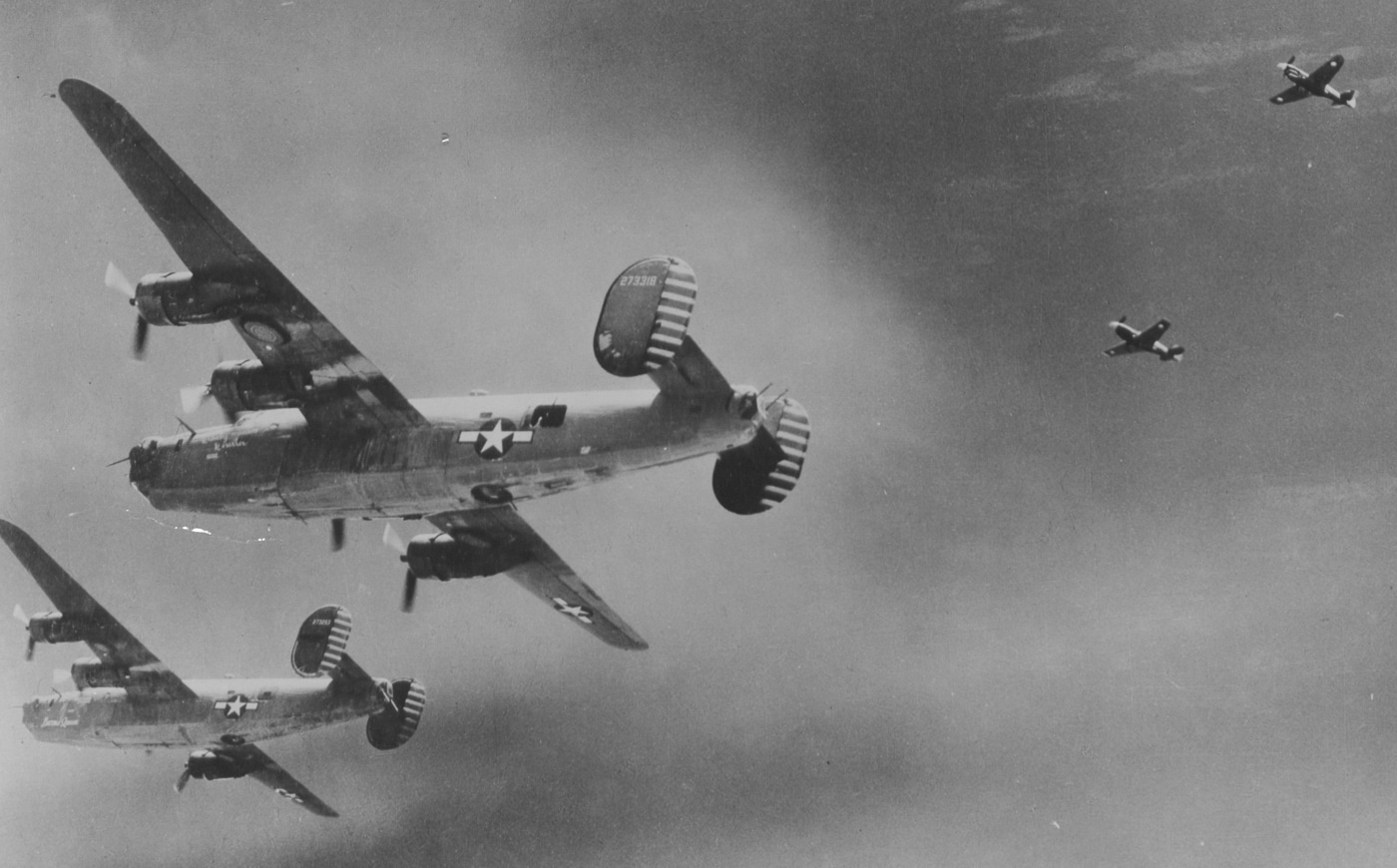 P-40 fighters escort B-24 bombers