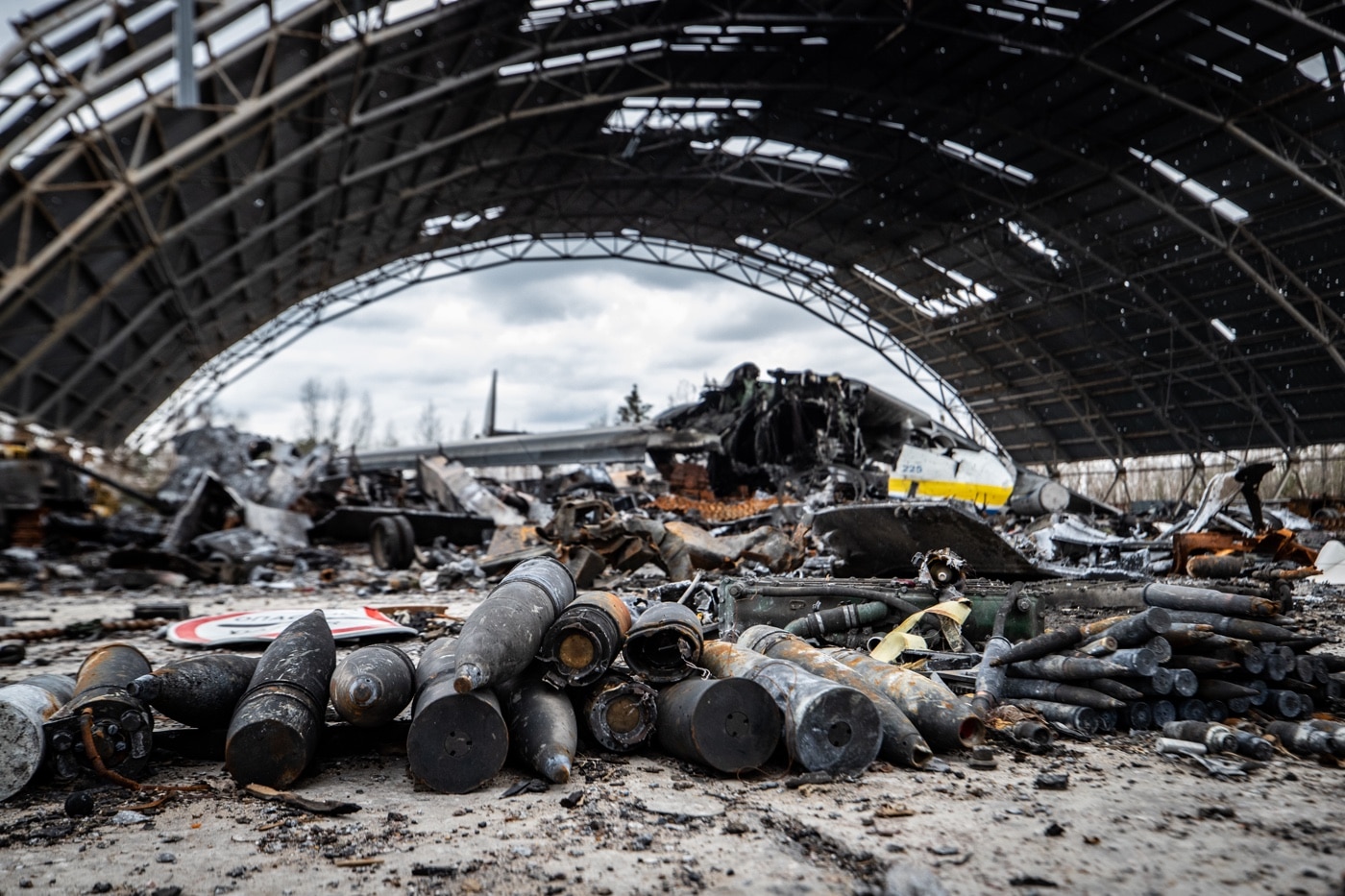 In this photograph, we see the damaged hangar containing the Antonov An-225 Mriya. 300 Ukrainian National Guardsmen were tasked to defend the airport. Deployed around the airport, they initially blocked the Russians from taking it. However, the superior numbers of the Russians overwhelmed them. In the ensuing weeks, Ukraine was able to take the airport back and send the Russians running. 